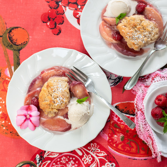 Peach & Raspberry Cobbler on a vintage plate with a scoop of Caramel Vanilla Bean Vegan Ice Cream