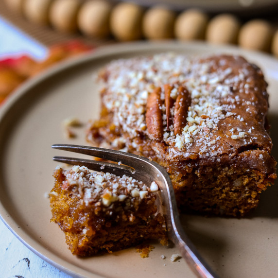 maple pecan blondie on a plate with a fork