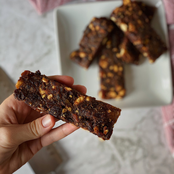 Close up of a homemade Lara Bar with a pile in the background