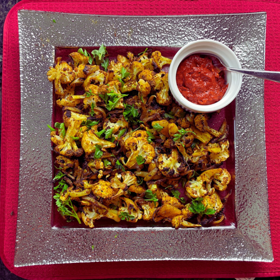 spicy cauliflower shawarma with harissa in a platter