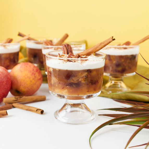 Apple cranberry pecan salad topped with cool whip in dessert glass.