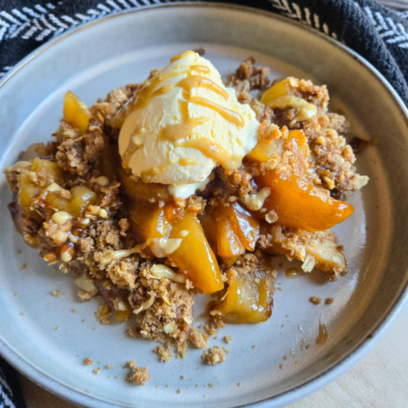 Golden apples and crumble finished with a creamy white dollop of ice cream.