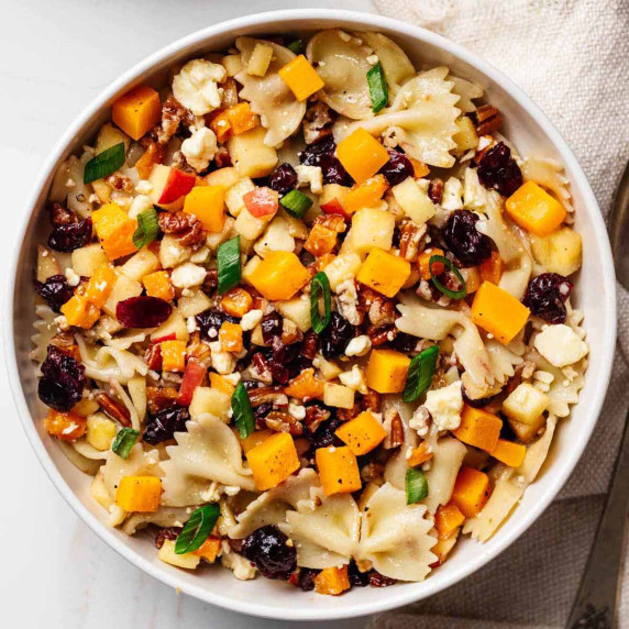 Overhead view of an autumn pasta salad in a white bowl