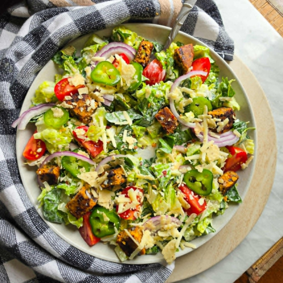 A colourful salad against a checkered towel.
