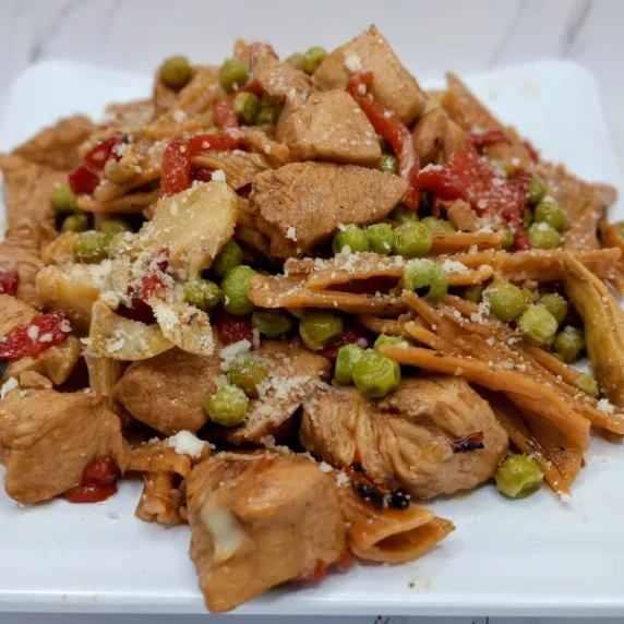 Boneless chicken bites sauteed with garlic, oil, roasted red peppers, artichokes, and peas.