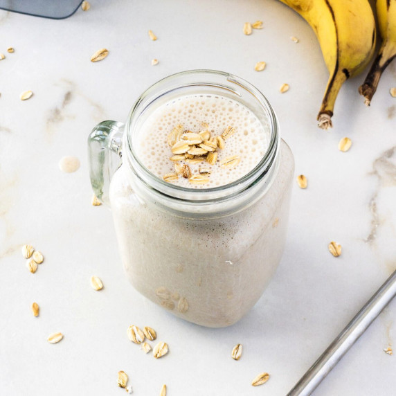 Banana oat smoothie served in mason jar.