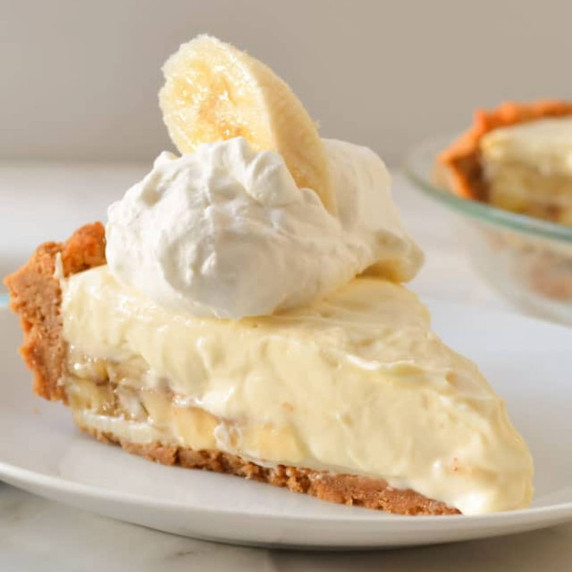 A slice of Banana Pudding Cheesecake on a white plate.