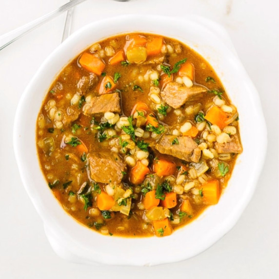 Top view of bowl of beef barley soup.