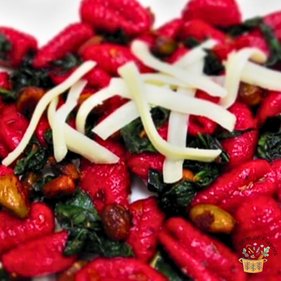 Beetroot Gnocchi with sweet potato, oat flour with butter, pistachios, kale, and garlic
