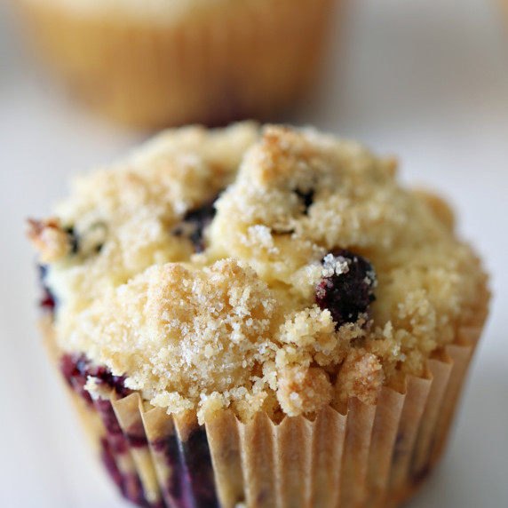 A buttermilk blueberry muffin in a parchment liner.