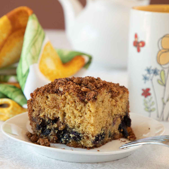 blueberry coffe cake slice with mug and teapoot 