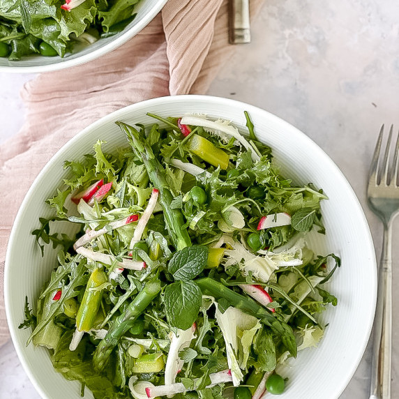 bowl of salad with pink napkin
