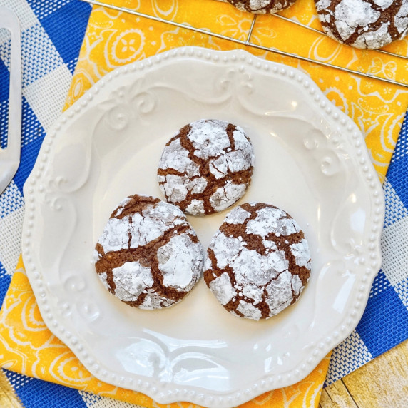 3 chocolate crinkle cookies on white plate