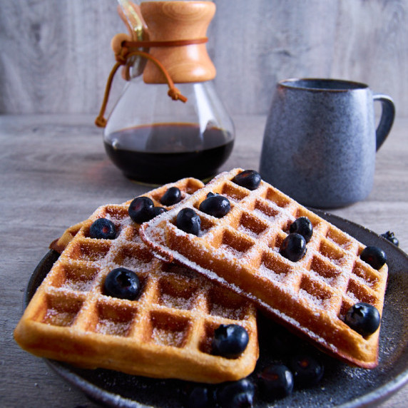 Buttermilk Sourdough Waffles with Protein and Wholewheat topped with icing sugar and blueberries