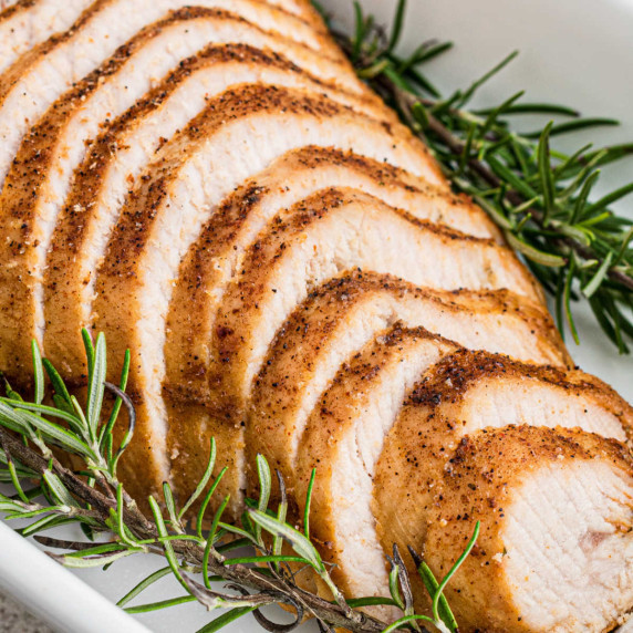 A sliced turkey breast sloping toward you.
