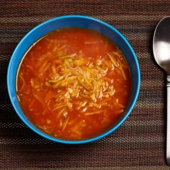 Carrot and Zucchini Soup served in a blue bowl