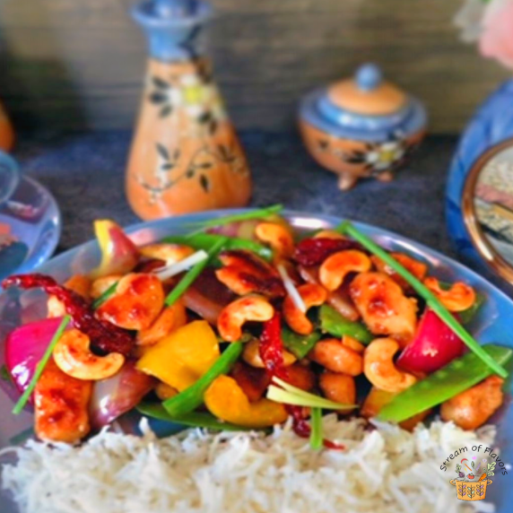 Stir-fried chicken, light soy sauce, sugar snap peas, onions, bell peppers and cashews