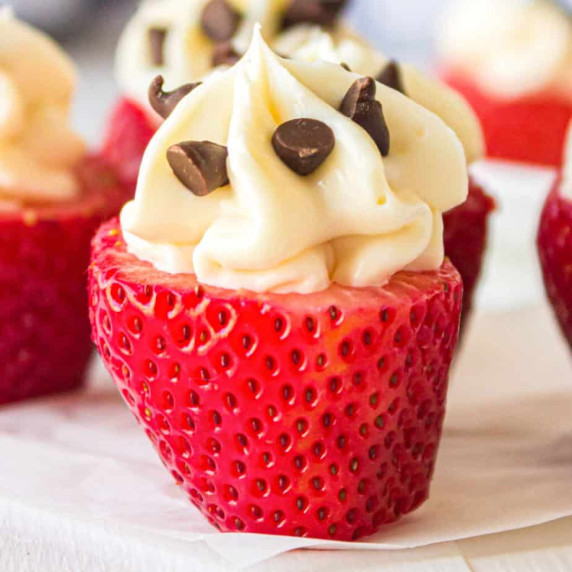 Strawberry standing on end filed with swirled cheesecake filling and mini chocolate chips.