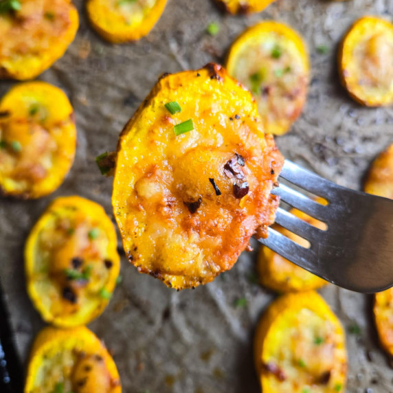 Perfectly roasted summer squash slices topped with golden brown cheese.