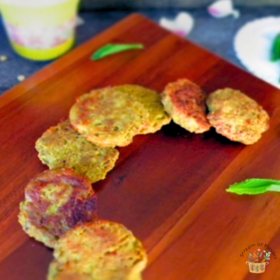 Chicken Galouti Kebabs with nuts and spices on a wooden board