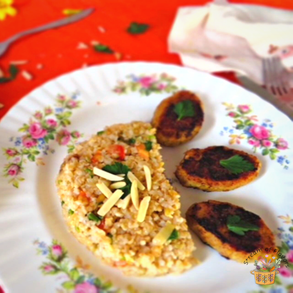 Chicken rissole with couscous and almonds garnished with cilantro on a floral plate