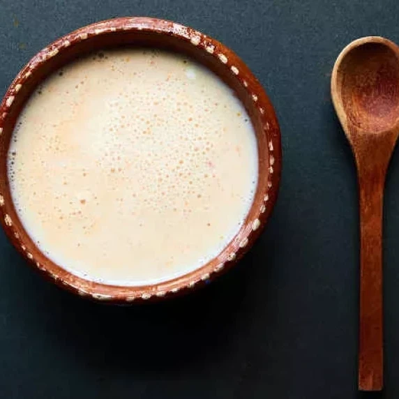 chipotle lime yogurt salsa in a bowl with wooden spoon on the side 