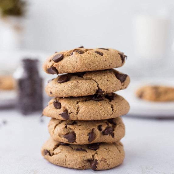 Stack of chewy chocolate chip protein cookies showing soft centers and crisp edges