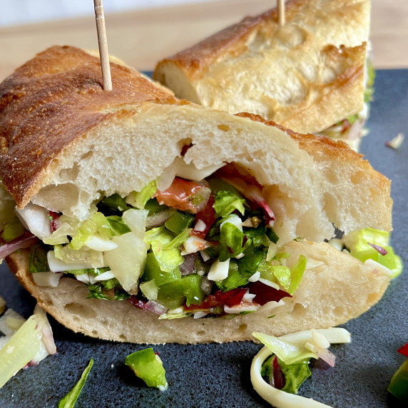 Chopped lettuce, green pepper, tomato, and onion tossed in a vinaigrette, served in a baguette. 