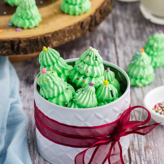 Gift tin filled with green meringues piped and decorated as Christmas Trees