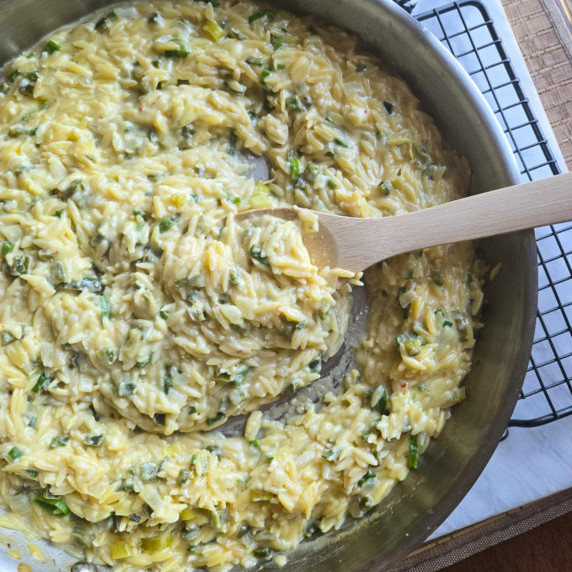 A skillet full of creamy orzo.