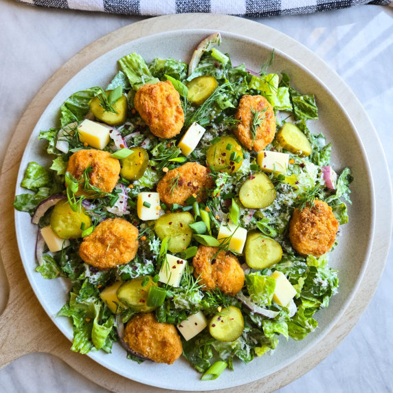 Gorgeous romaine salad with golden chik'n, red onions, aged white cheddar and greens