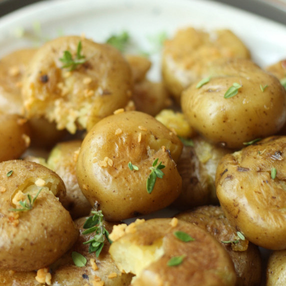 finished crispy garlic smashed potatoes on a plate