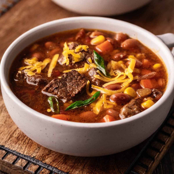 Crock Pot cowboy soup in a large soup mug