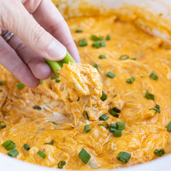 Crockpot Buffalo Chicken Dip RECIPE garnished with green onion.
