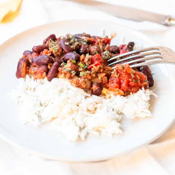 Chili made in a crockpot served with white rice