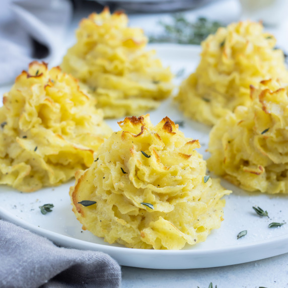 Duchess Potatoes RECIPE served on a white plate. 