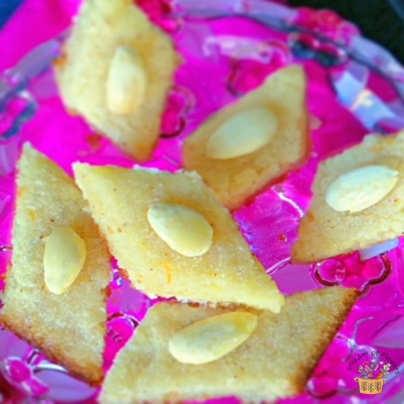 Basbousa cake slices with semolina, fresh coconut, and yogurt with in lemon sugar syrup