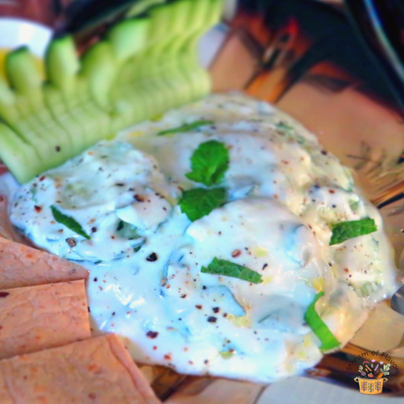 Easy Tzatziki with mint, herbs, yogurt, olive oil and cucumber slices with bread