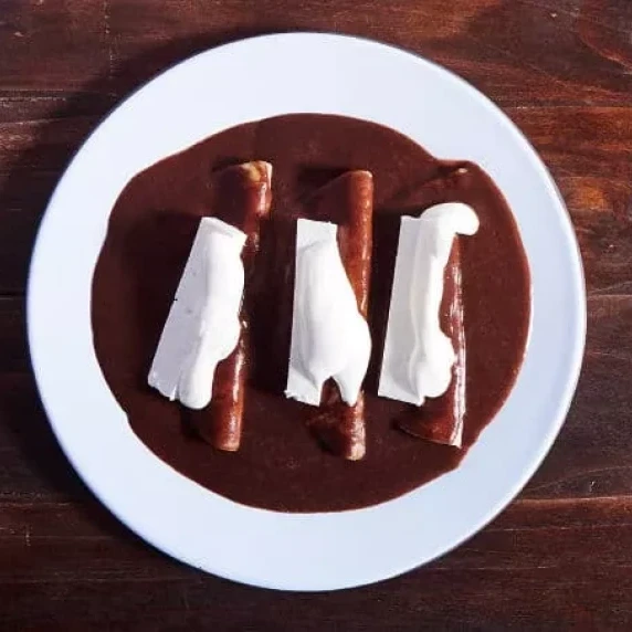 Enchiladas with Bean Sauce in white plate