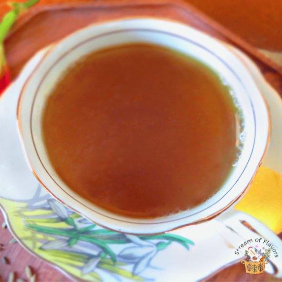 Fennel and Cumin Tea with fennel, cumin seeds, fresh ginger slices, and honey in a white tea cup