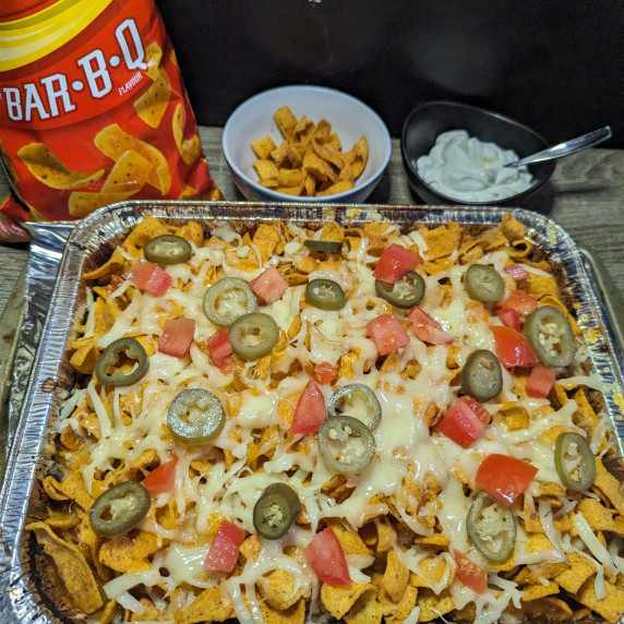 fritos chicken casserole with a bag of fritos and a bowl of sourcream