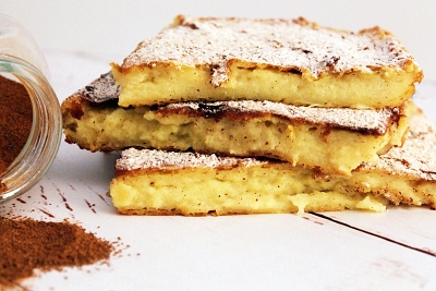 Slices of Laconian Galatopita, dusted with powdered sugar and cinnamon.