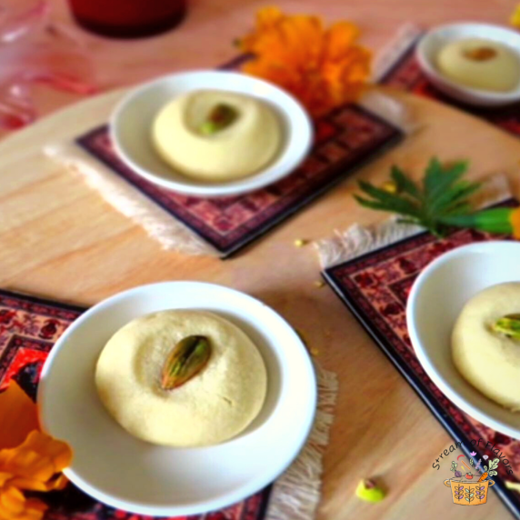 Ghraybeh cookies garnished with pistachios in small plates on a wooden board