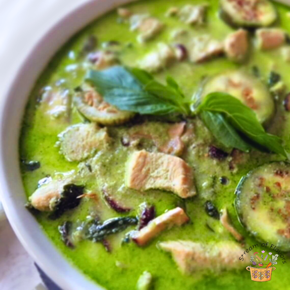 Thai Green Chicken Curry with Asian eggplants and mushrooms in a white bowl