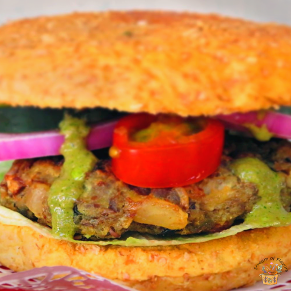 Ground Lamb Burgers with beans with homemade mint sauce and peppers, tomato, onions, and cucumber