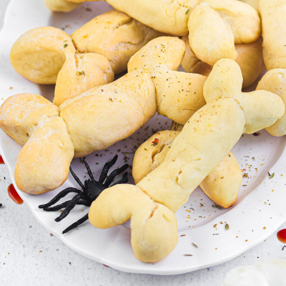 A plate of bone shaped breadsticks on a platter.