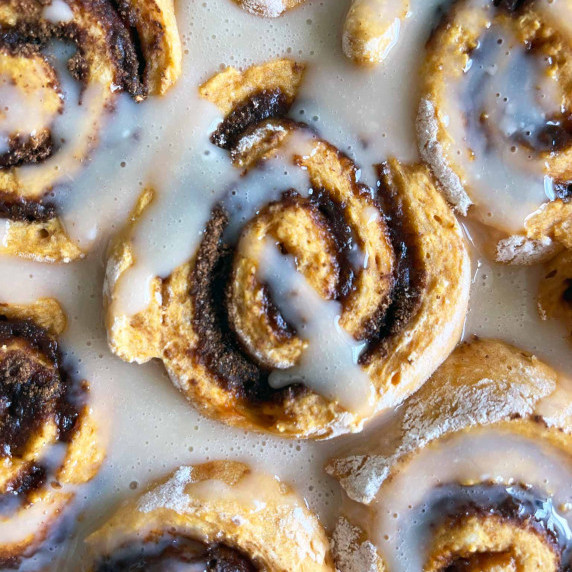 zoomed in view of healthier pumpkin cinnamon rolls glazed