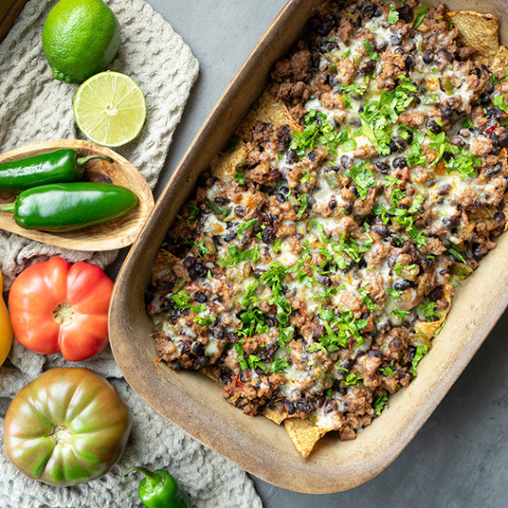 Jalapeno loaded nachos in stoneware baking dish
