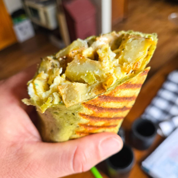 Golden brown tortilla filled with roasted potatoes and fluffy golden eggs.