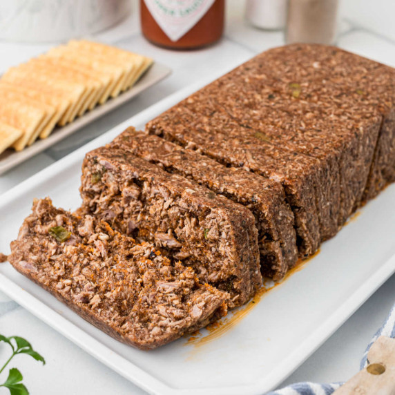 A loaf of Mock Hog Head Cheese, sliced and ready to eat.